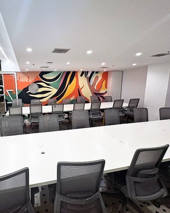Briefing room seating facing the mural wall used for reviews and management drills