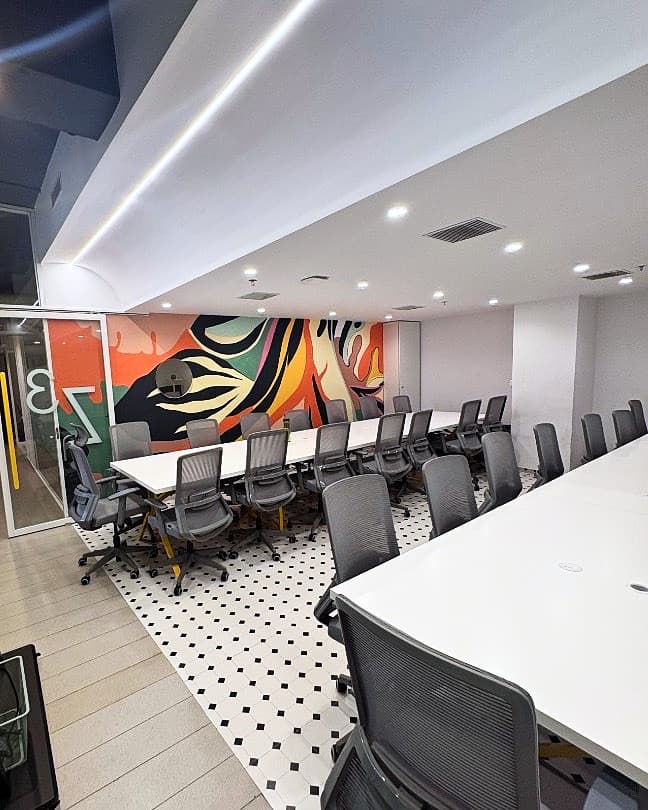 Main Corrivex training bay with mural backdrop, ready for small-batch mentorship sessions