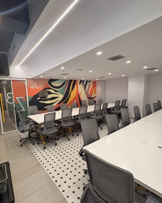 Main Corrivex training bay with mural backdrop, ready for small-batch mentorship sessions