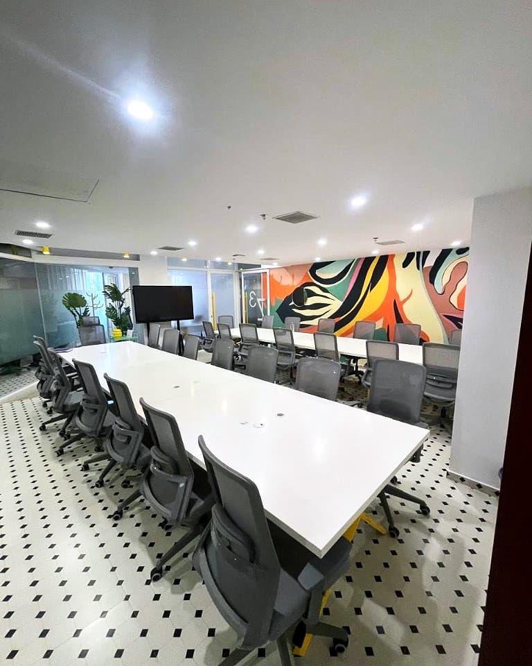 Corrivex training floor with a long briefing table and mural wall at HiLITE Business Park, Kozhikode