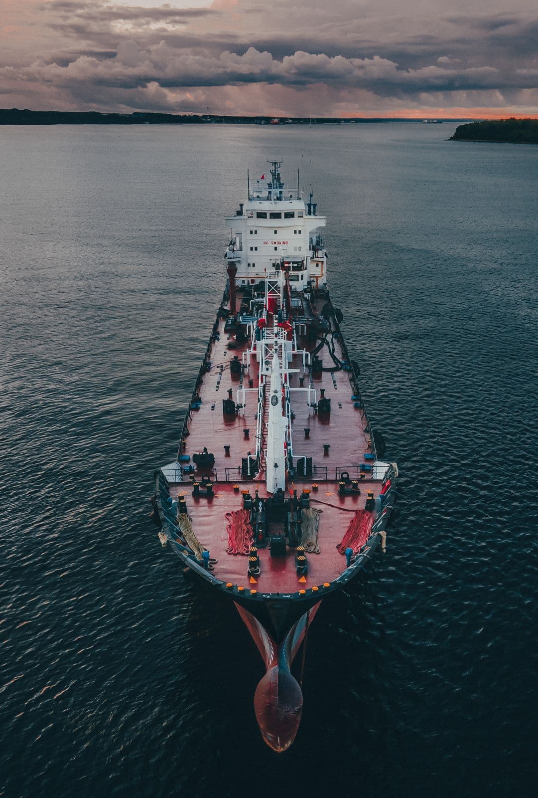 Cargo ship under way on the open sea at twilight — sea freight operations taught at Corrivex, Kozhikode