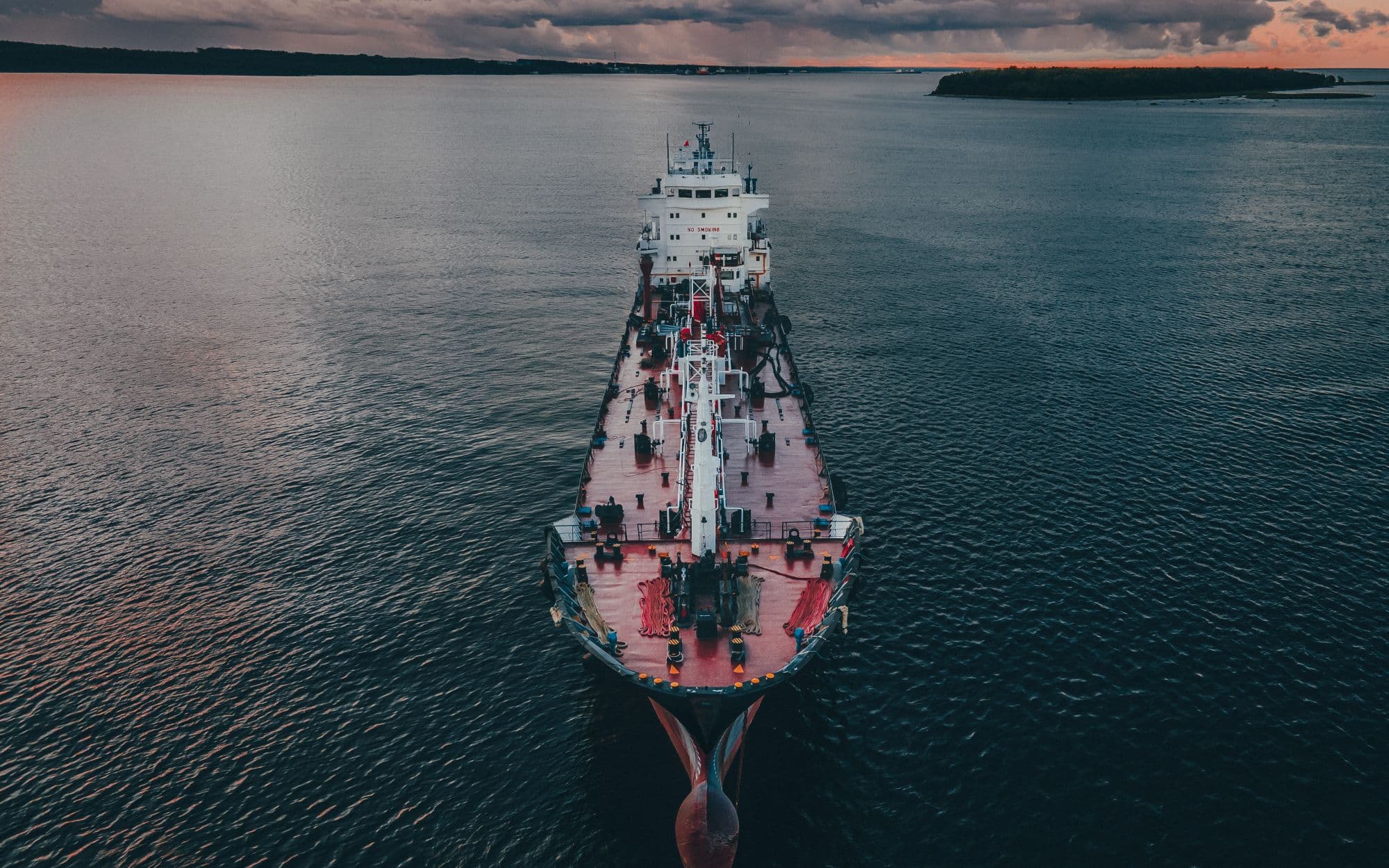 Cargo ship under way on the open sea at twilight — sea freight operations taught at Corrivex, Kozhikode